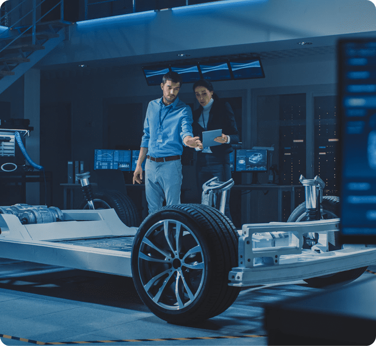Engineers examining electric vehicle chassis
